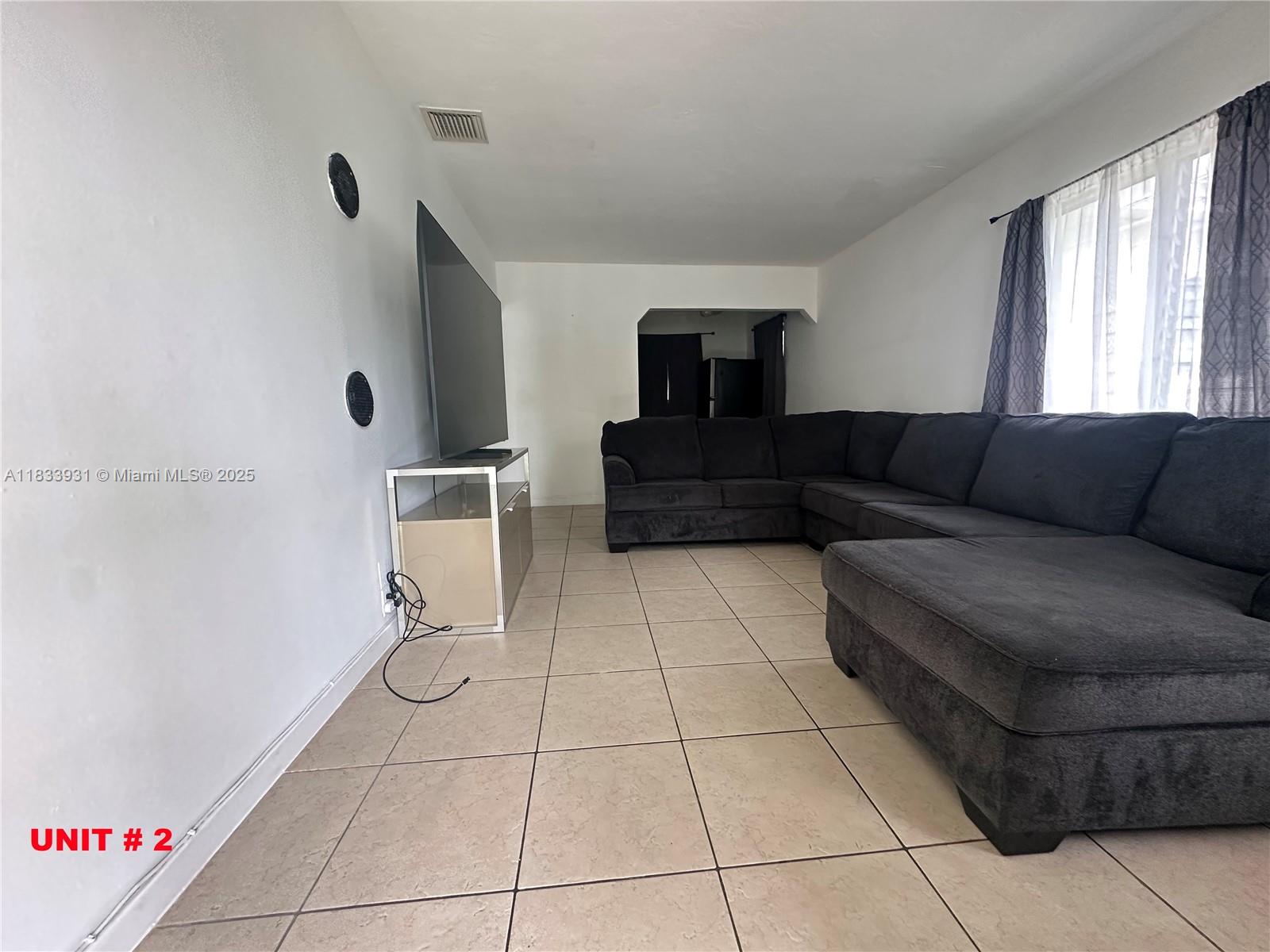 809 Northeast 2nd Street, Unit 12 Hallandale Beach, FL 33009 - Photo 11 of 19 a living room with furniture and a rug