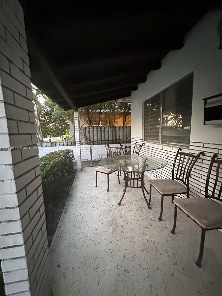 809 Northeast 2nd Street, Unit 12 Hallandale Beach, FL 33009 - Photo 9 of 19 a building outdoor space with patio furniture and potted plants