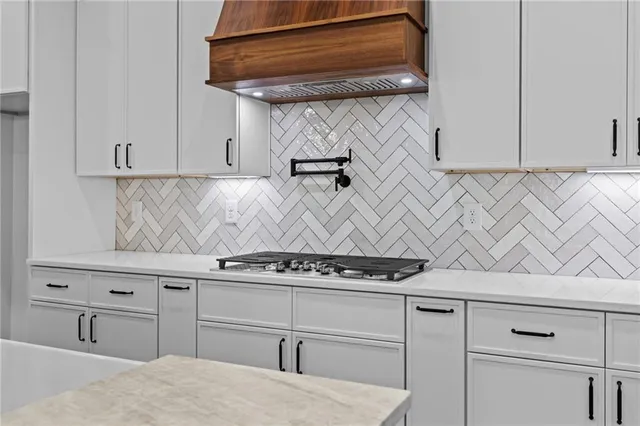 a kitchen with stainless steel appliances granite countertop a stove and a sink