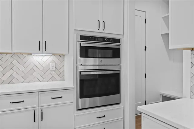 a view of a room with window hardwood floor and a ceiling fan