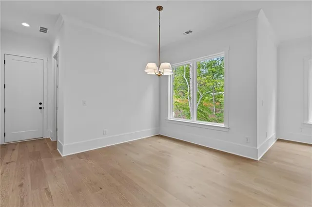 a view of a walk in closet with empty racks