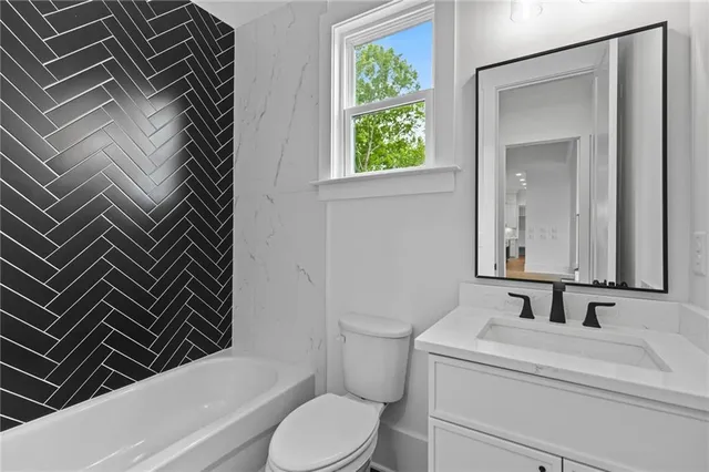 an empty room with wooden floor and ceiling fan