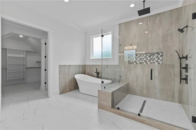 a bathroom with a tub a sink and shower