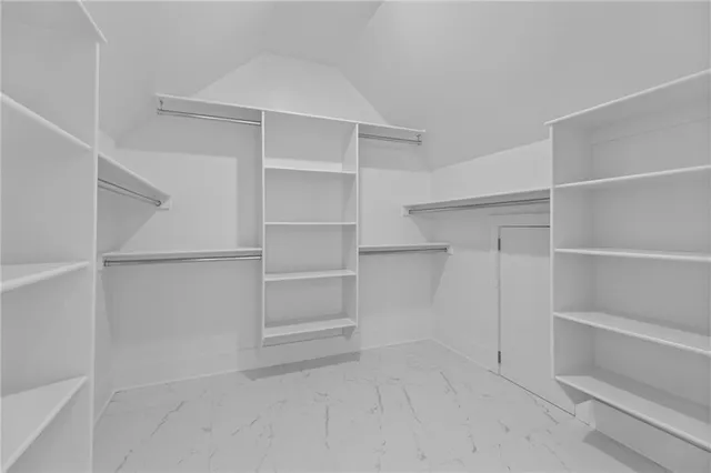 a kitchen with white cabinets and sink