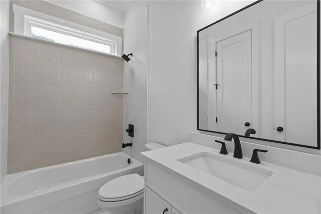 an empty room with closet and windows