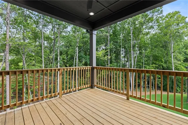 an aerial view of residential house with outdoor space and trees all around