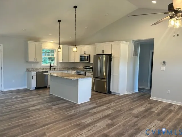 a kitchen with stainless steel appliances a refrigerator sink and microwave