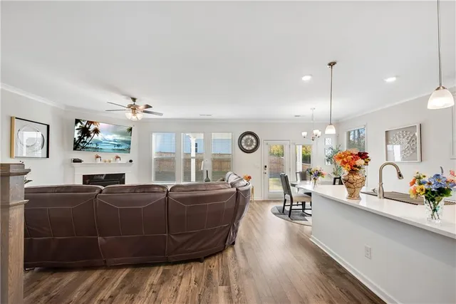 a living room with furniture a flat screen tv and a large window