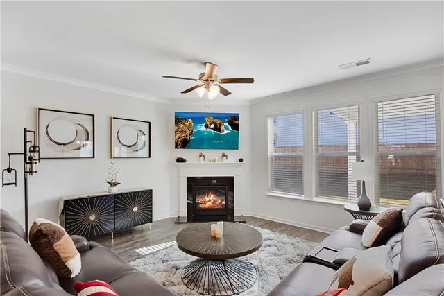 a living room with furniture a window and a fireplace