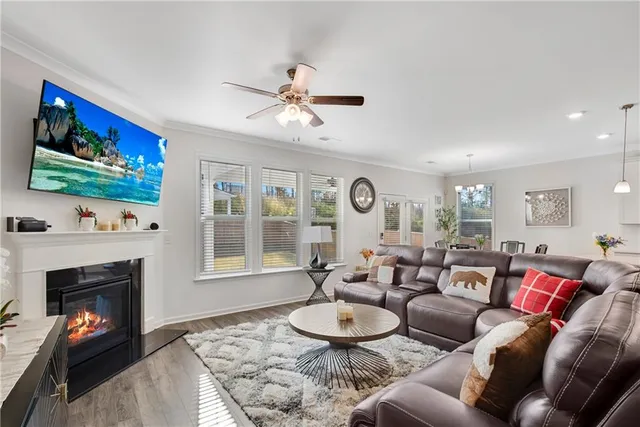 a living room with furniture a fireplace and a flat screen tv