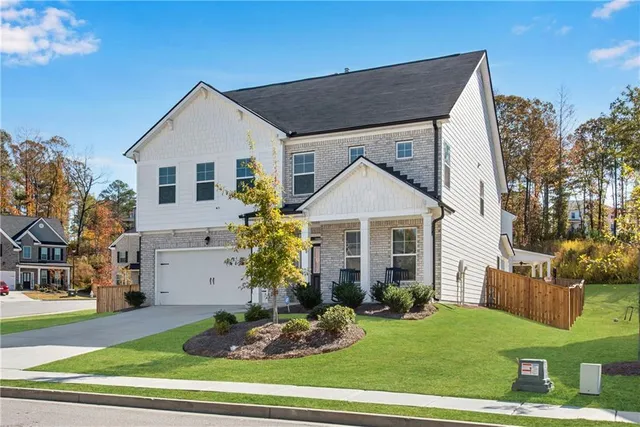 a front view of a house with a yard