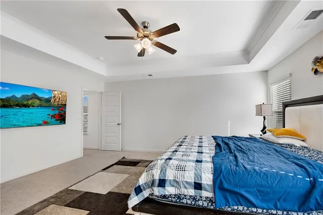 a bedroom with a bed and a large mirror