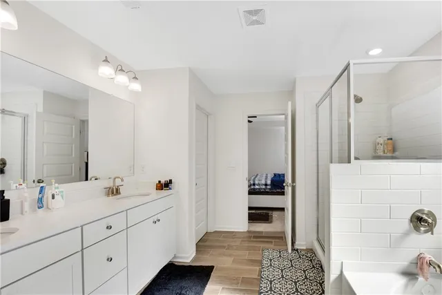 a spacious bathroom with double sink and a mirror