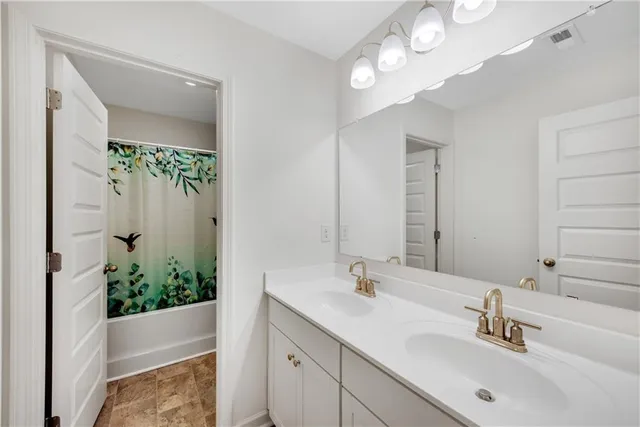 a bathroom with a double vanity sink and a mirror