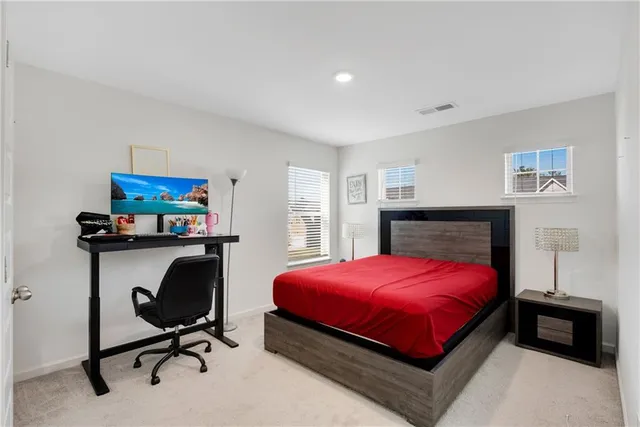 a bedroom with a bed and a desk