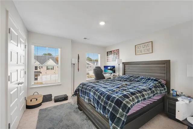 a bedroom with a bed and dresser