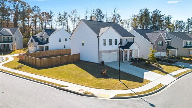 a view of yard from deck with patio