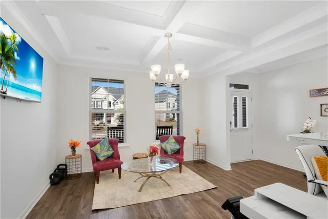 a living room with dining room and wooden floor