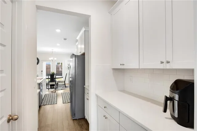 a kitchen with stainless steel appliances a refrigerator sink and cabinets