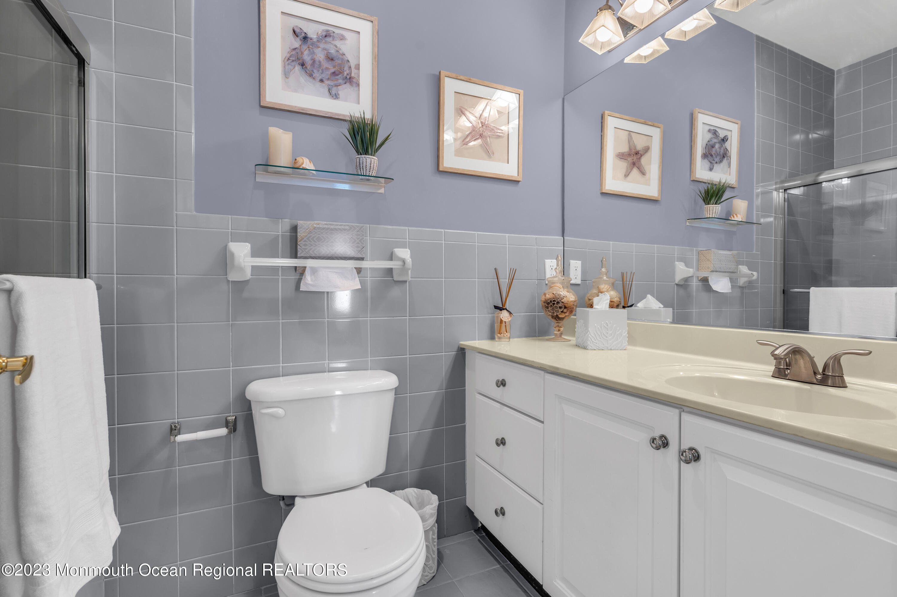 239 Beach Front, Unit 1 Manasquan, NJ 08736 - Photo 20 of 31 a bathroom with a toilet sink and mirror