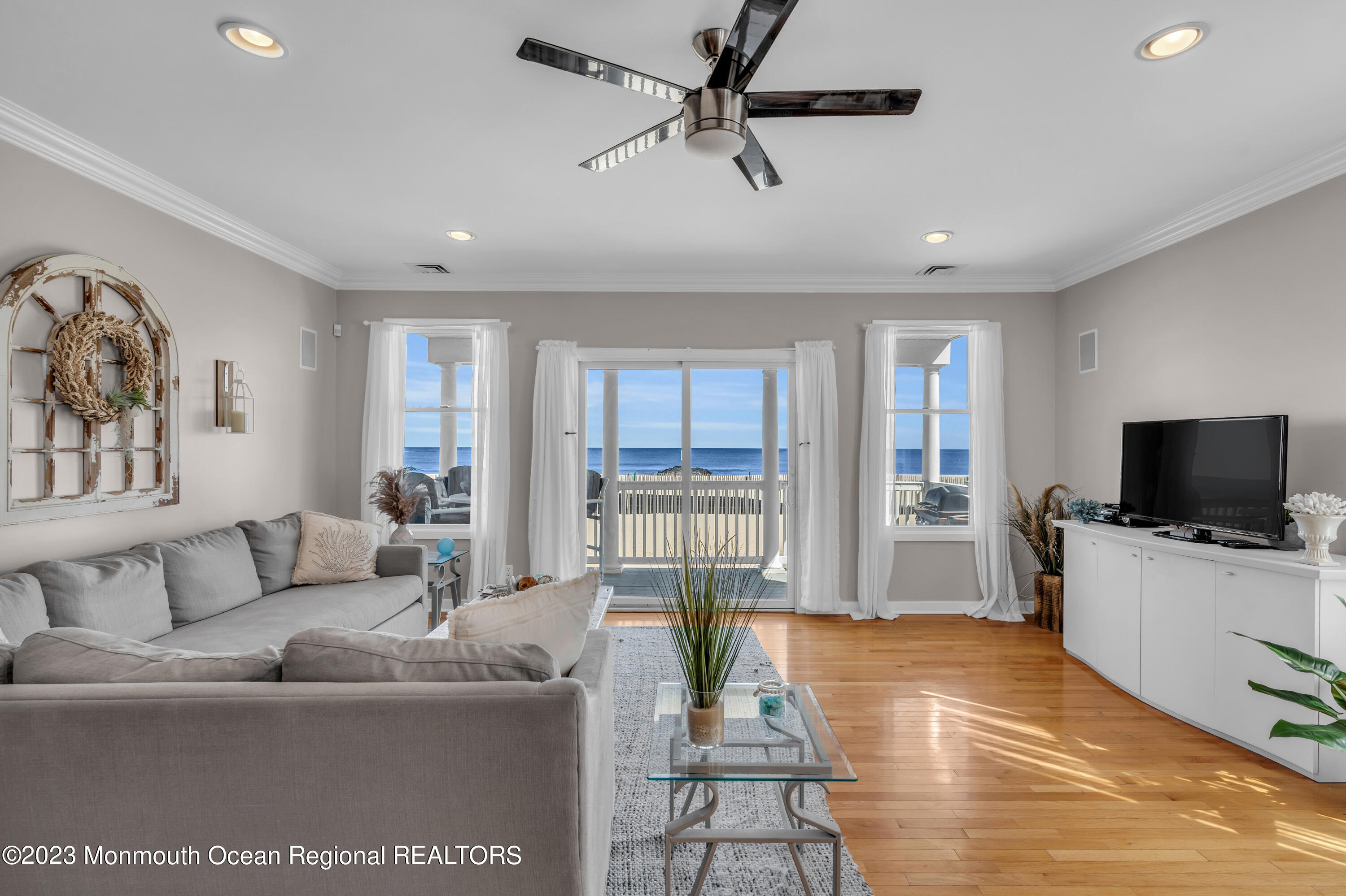 239 Beach Front, Unit 1 Manasquan, NJ 08736 - Photo 7 of 31 a living room with furniture and a flat screen tv