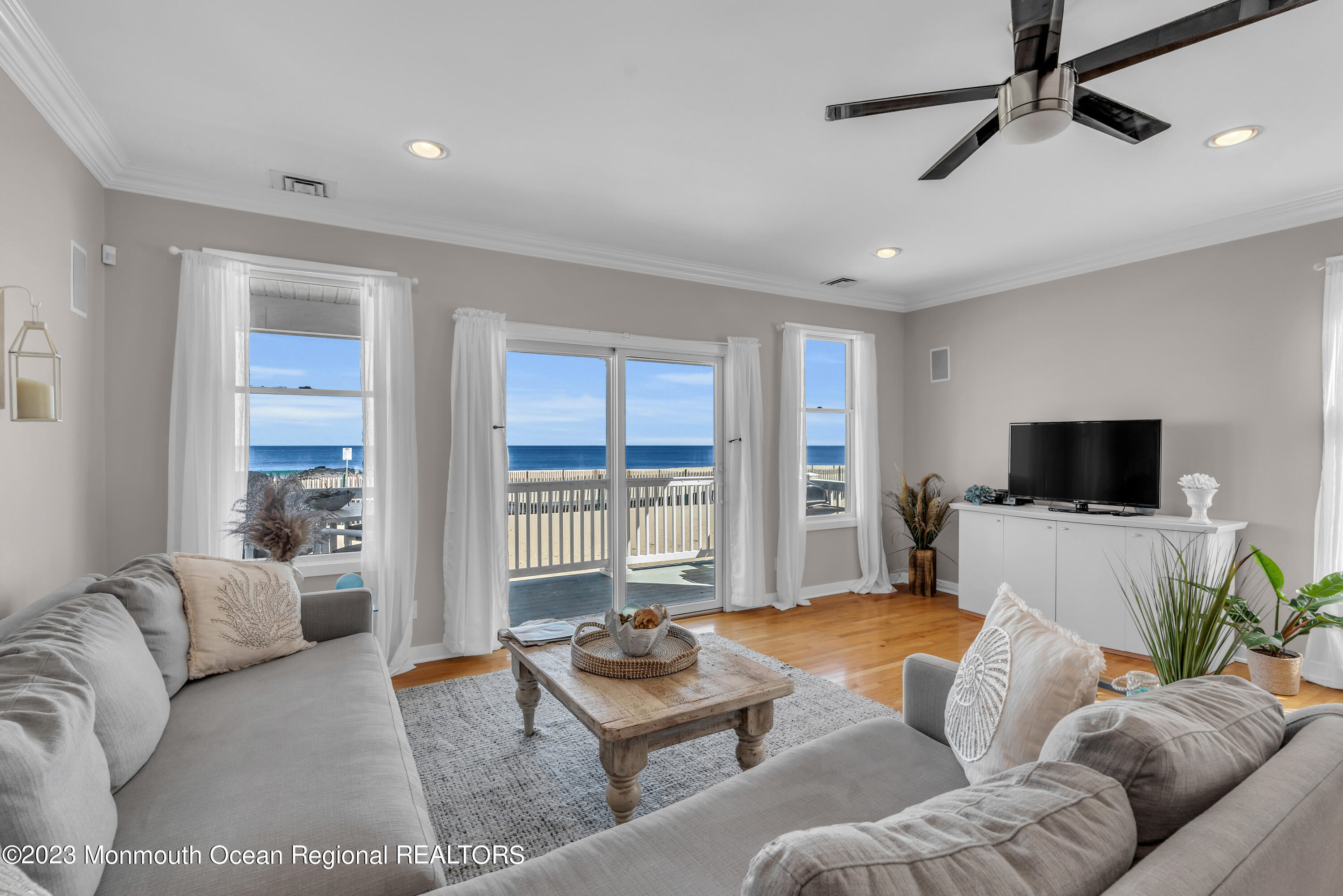 239 Beach Front, Unit 1 Manasquan, NJ 08736 - Photo 8 of 31 a bedroom with furniture and a flat screen tv