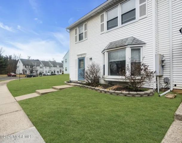 a view of a house with a yard and sitting area
