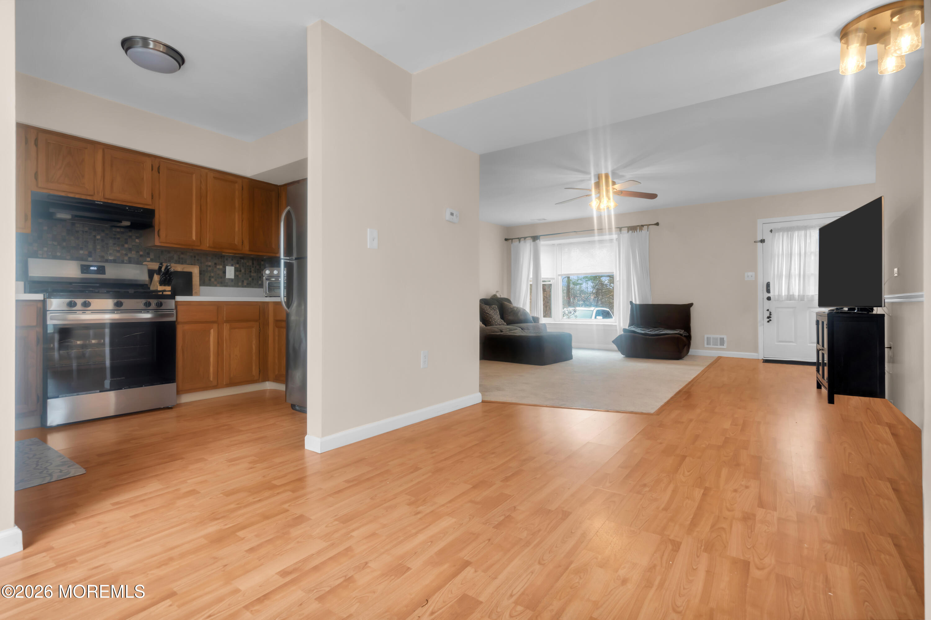 30 Shilling Way Jackson, NJ 08527 - Photo 8 of 28 a view of kitchen with stainless steel appliances wooden floor and living room