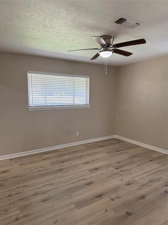 711 Farmington Road Howe, TX 75459 - Photo 11 of 21 a view of an empty room with wooden floor and a window