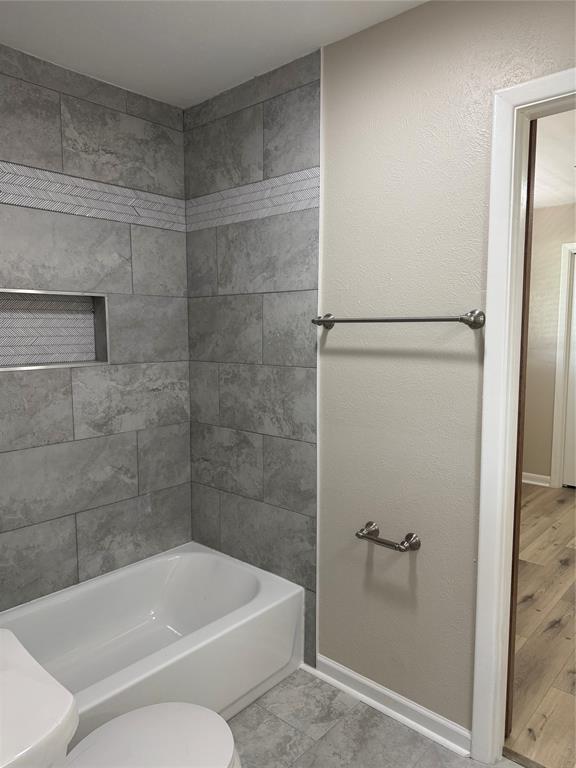 711 Farmington Road Howe, TX 75459 - Photo 17 of 21 a bathroom with a toilet and bathtub
