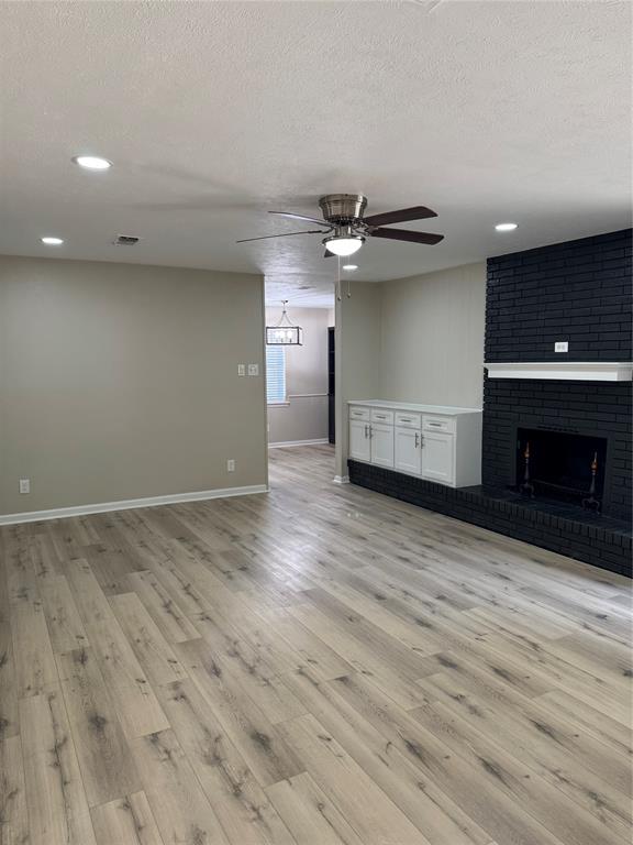 711 Farmington Road Howe, TX 75459 - Photo 4 of 21 an empty room with wooden floor and a ceiling fan