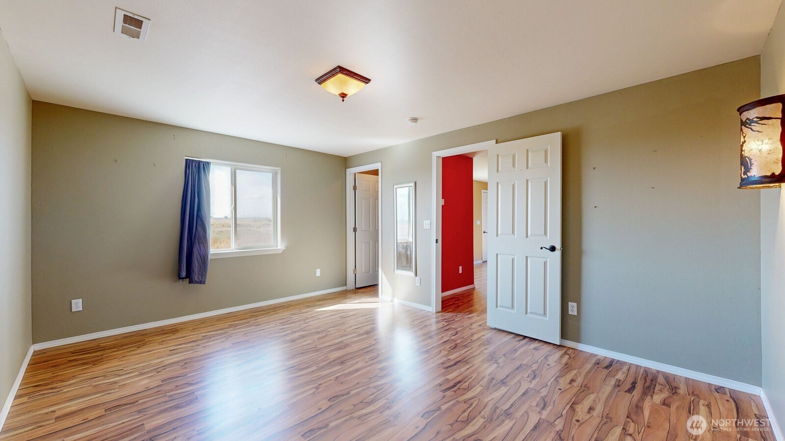 321 Kent Way Eltopia, WA 99330 - Photo 14 of 35 a view of an empty room with window and wooden floor