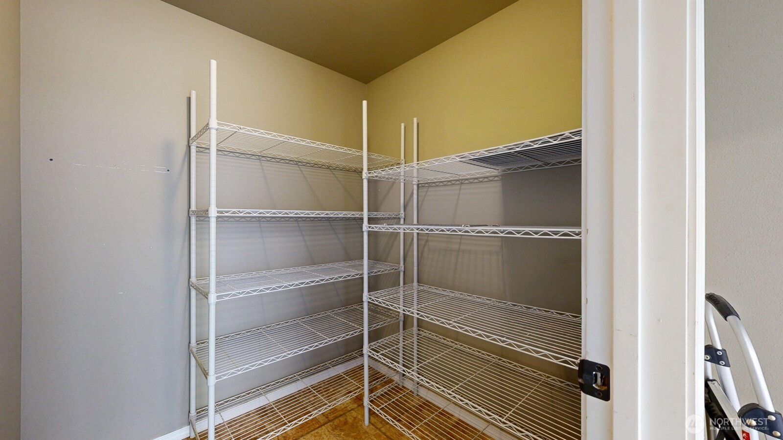 321 Kent Way Eltopia, WA 99330 - Photo 17 of 35 a bathroom with a walk in closet and wooden floor