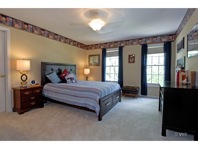 3530 Monarch Circle Naperville, IL 60564 - Photo 11 of 19 a bedroom with a bed and a chandelier