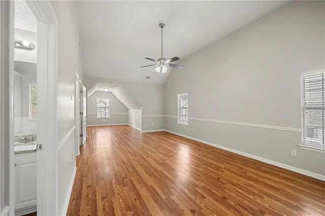 a view of a room with wooden floor and white walls