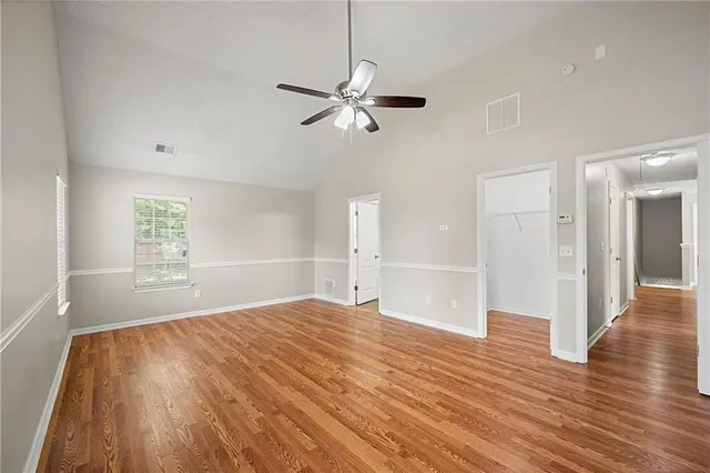 a view of empty room with wooden floor