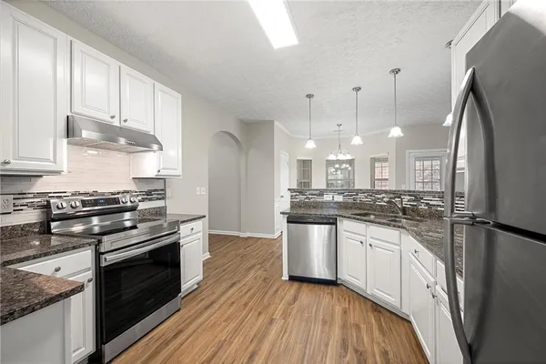 a kitchen with stainless steel appliances a sink stove and refrigerator