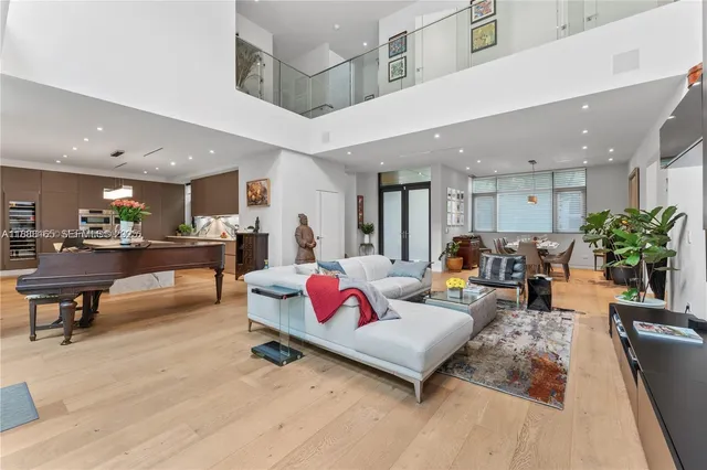 a living room with furniture and kitchen view
