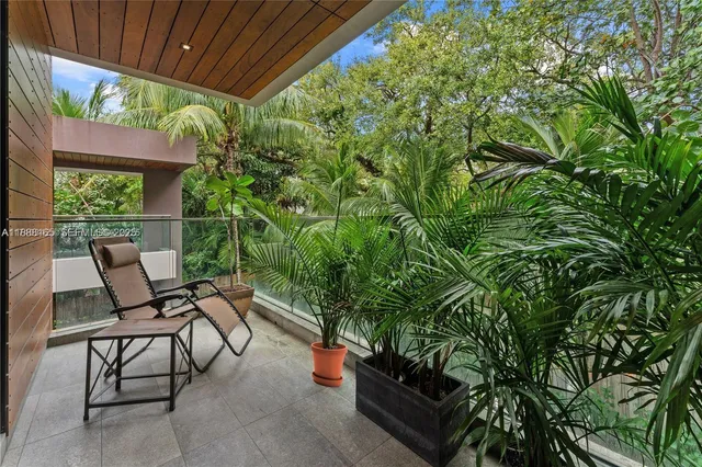 a view of backyard with outdoor seating and green space