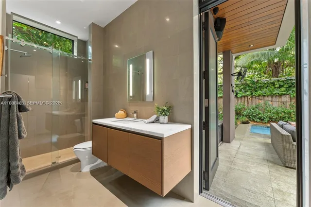 a view of a bathroom with a tub shower and sink
