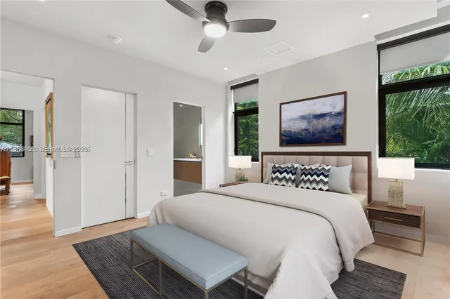 a bedroom with a bed and a painting on the wall