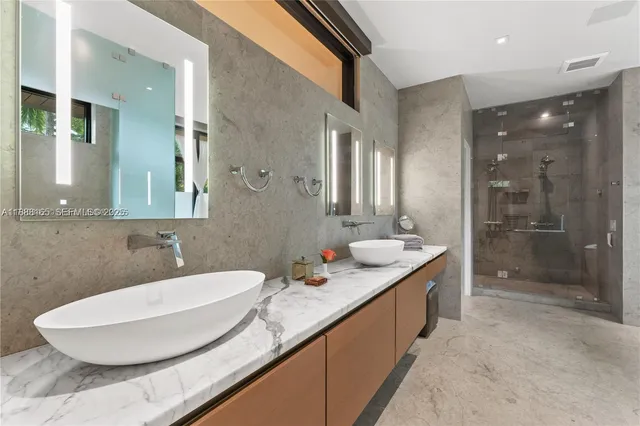 a bathroom with a granite countertop sink and a mirror