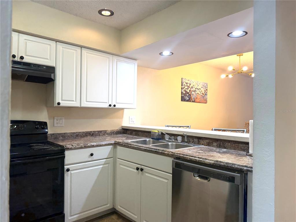 1340 Cypress Cove Court Inverness, FL 34450 - Photo 13 of 30 a kitchen with stainless steel appliances granite countertop a sink and cabinets