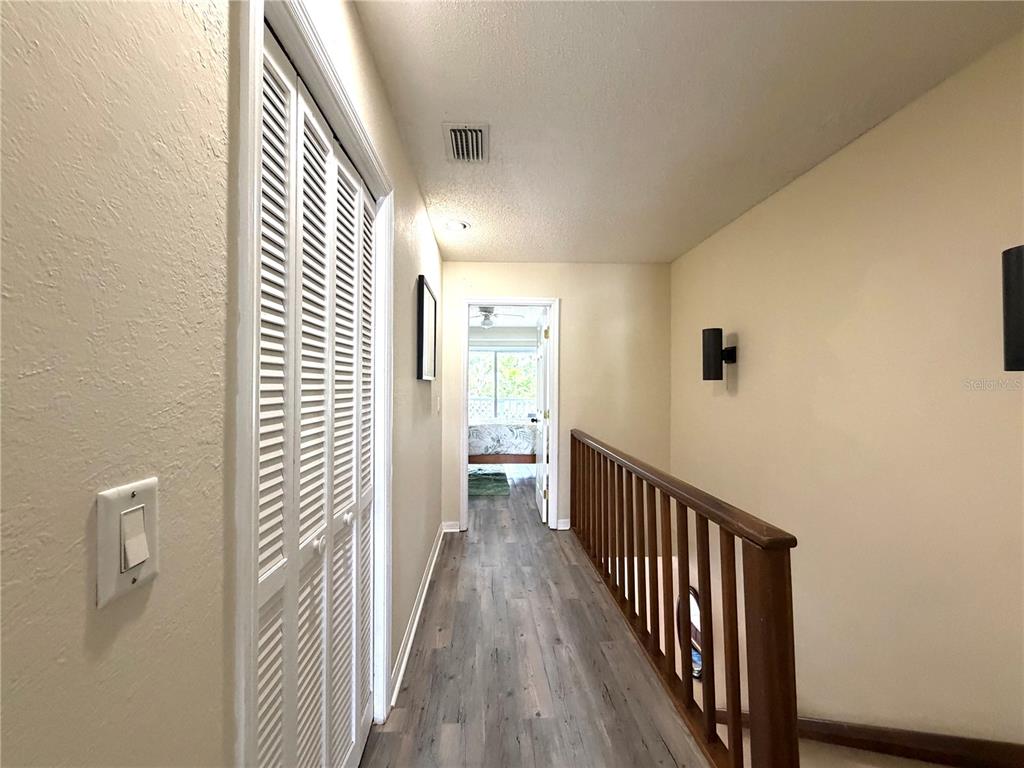 1340 Cypress Cove Court Inverness, FL 34450 - Photo 14 of 30 a view of a hallway with wooden floor and staircase