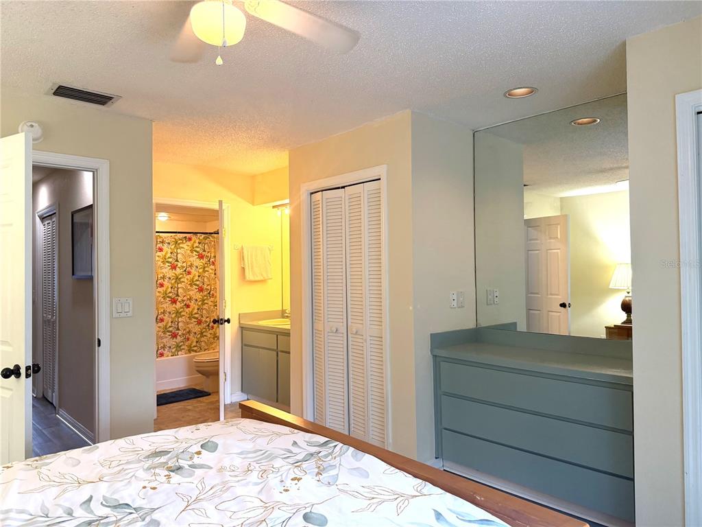1340 Cypress Cove Court Inverness, FL 34450 - Photo 15 of 30 a bedroom with a bed and a chandelier