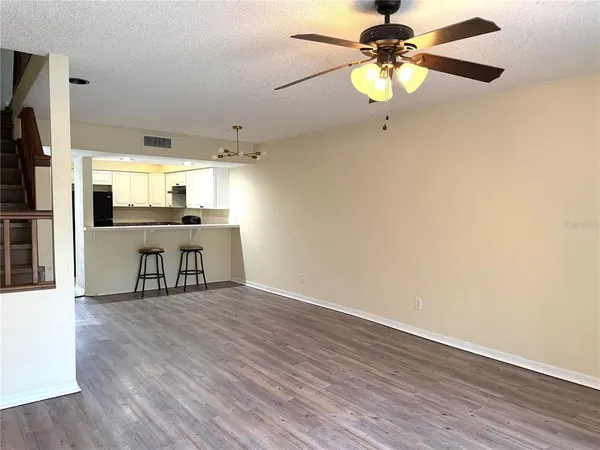 a view of a kitchen with a sink stainless steel appliances and a chandelier