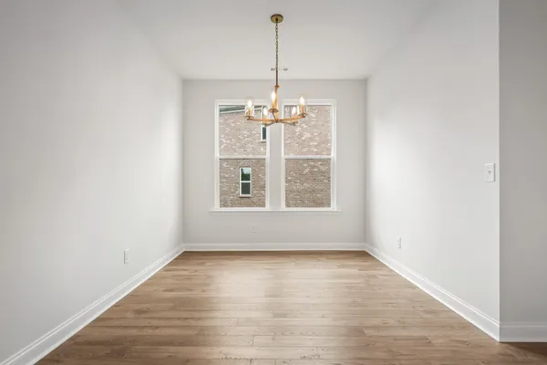 a view of a room with wooden floor chandeliers