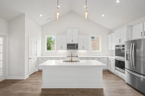 a close view of kitchen island kitchen island stainless steel appliances a sink and a window