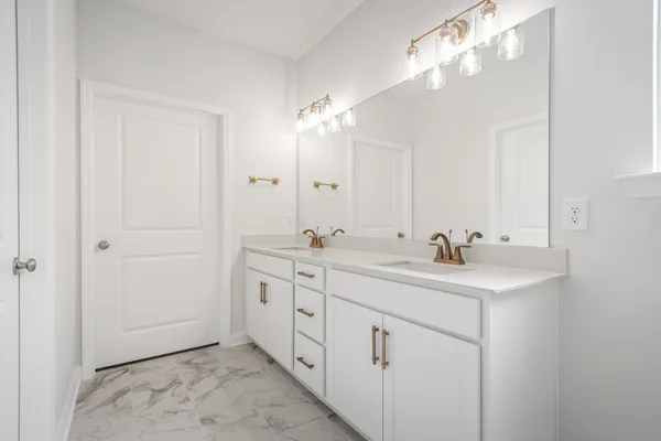 a bathroom with 2 sink and a mirror