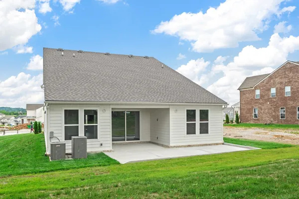 a front view of house with yard and green space